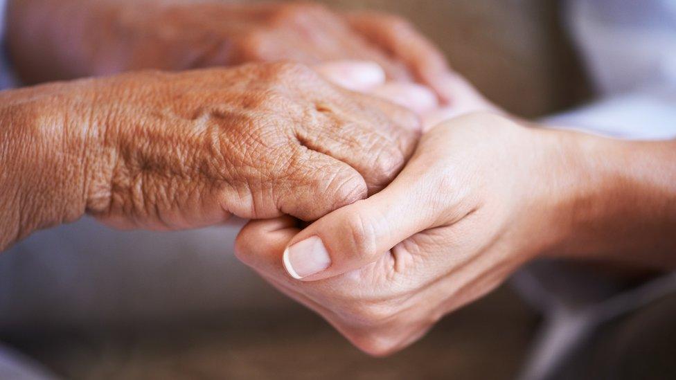 Young and older women holding hands