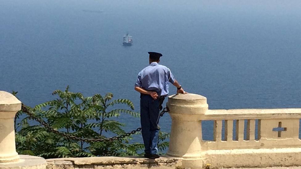 Policeman looking out to sea