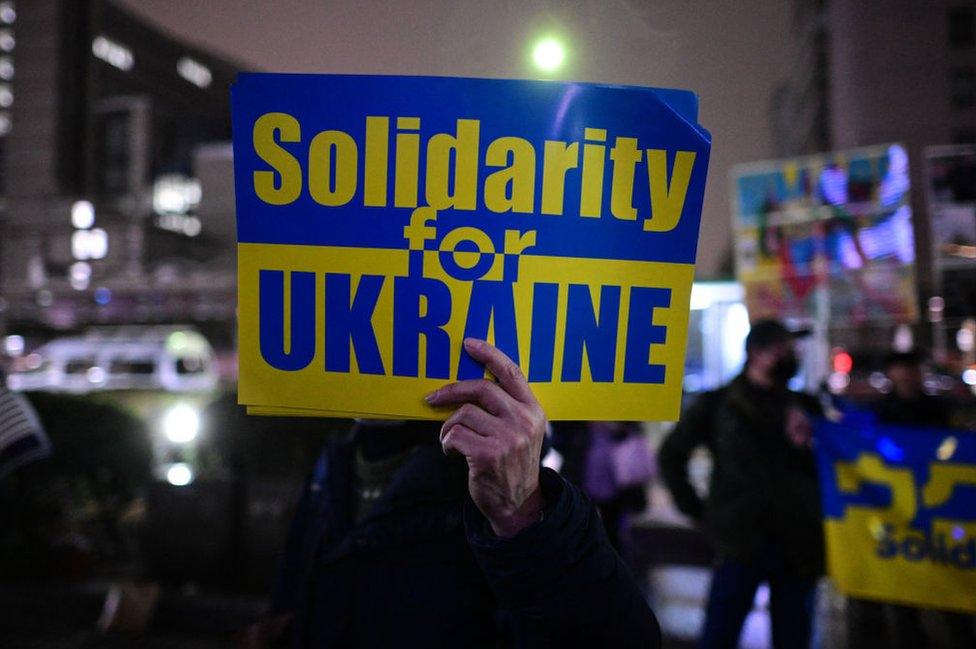 People take part in a candlelight vigil outside UN University to mark the one year anniversary of the Russian invasion of Ukraine, in Tokyo on February 24, 2023.