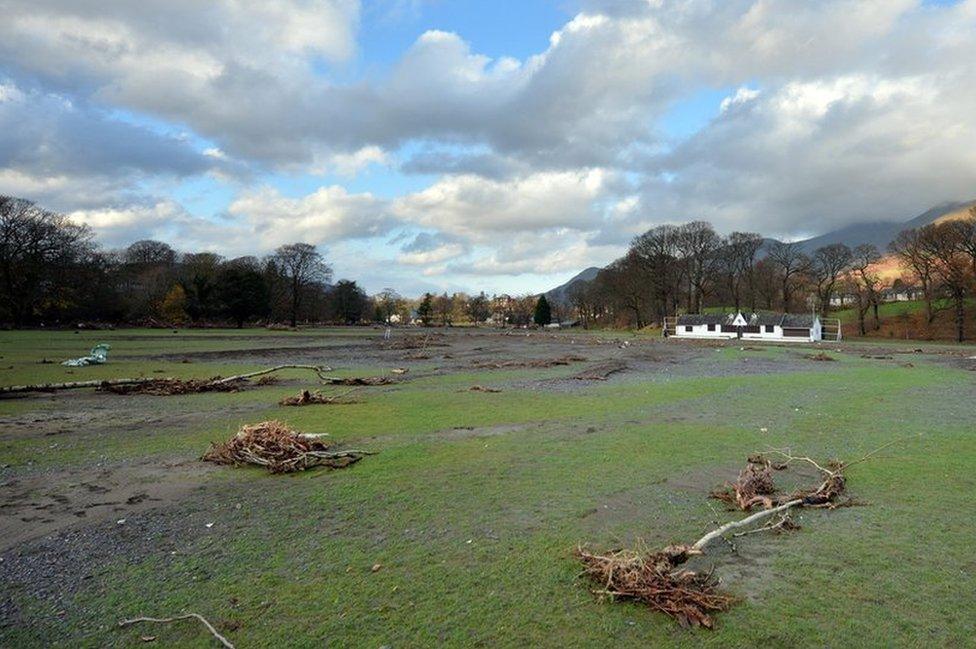 Debris covers the pitch at Keswick Cricket Club in the wake of Storm Desmond