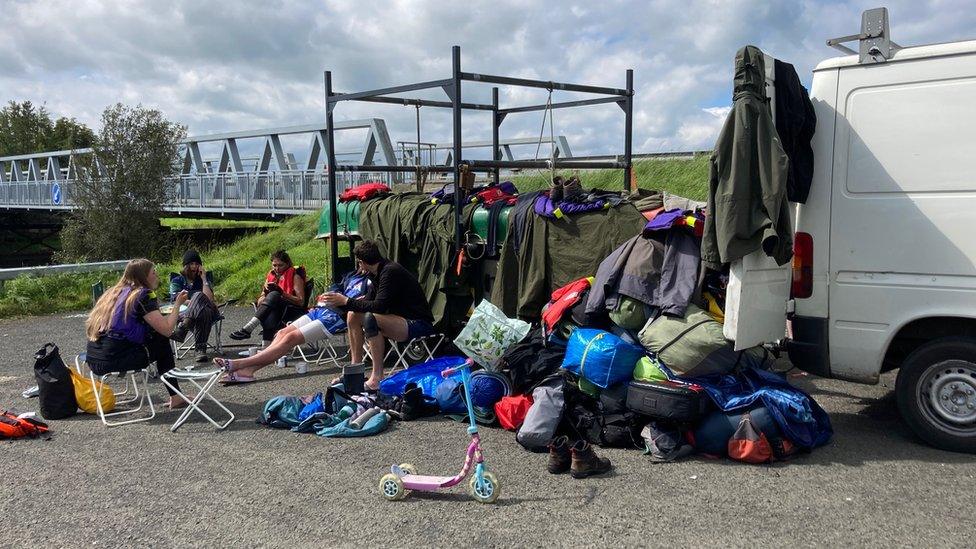 Members of the crew sitting around at a camp