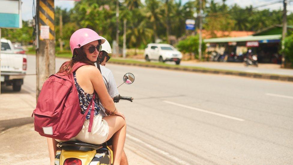 Woman and man on moped