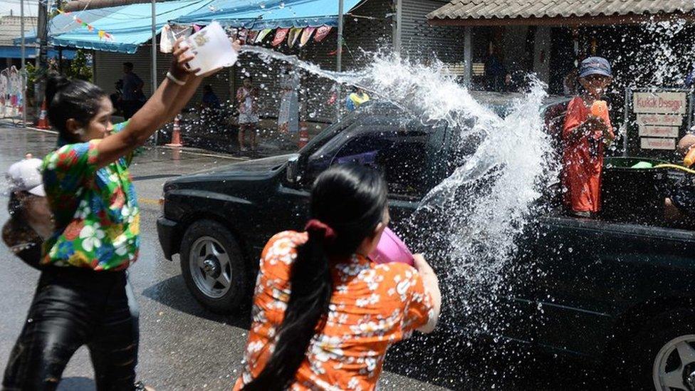 Revellers throw water on passing motorists