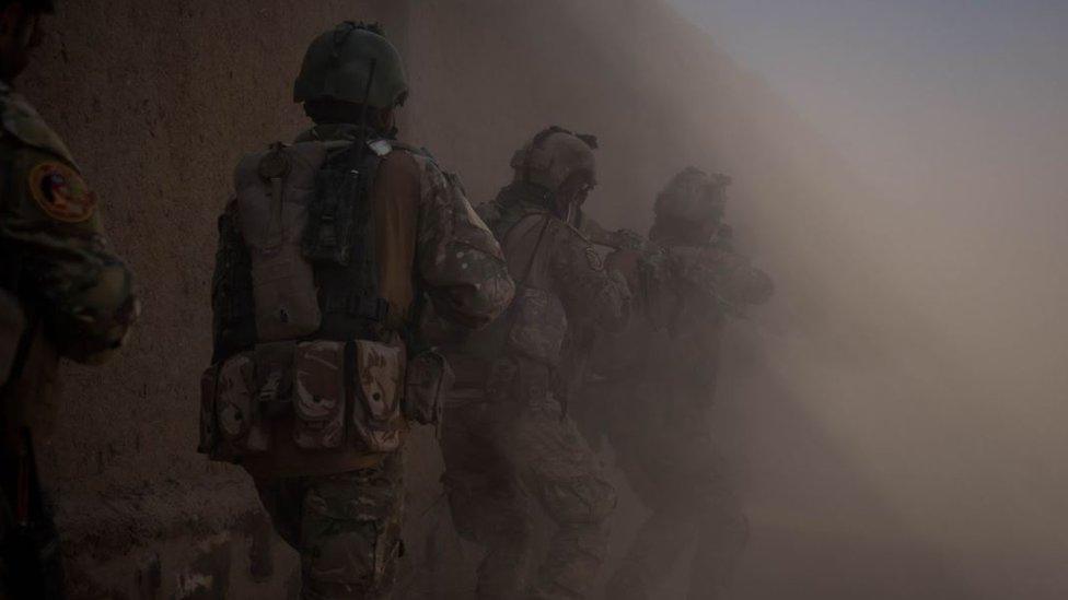 A group of Afghan soldiers, seemingly working at night