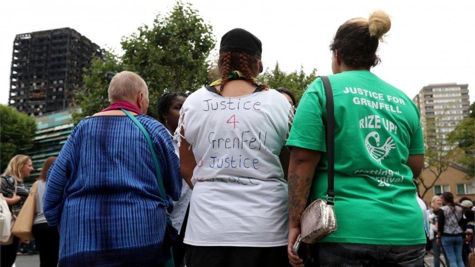 People attend a silent march to pay respect to those killed in the Grenfell Tower disaster