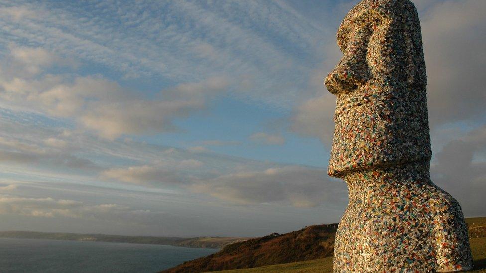 An Easter Island-style sculpture coated with plastic waste