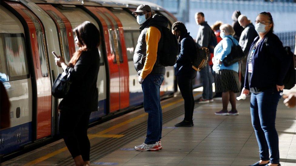 Commuters at Canning Town underground station in east London