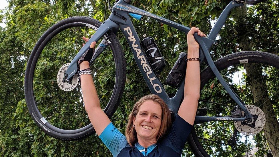 woman holding a bike