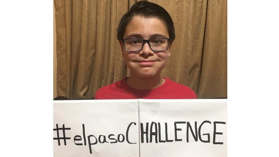 Reuben Martinez holding a sign saying elpasoCHALLENGE