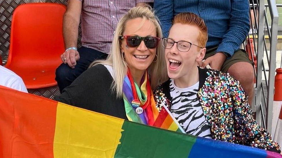 Nina Green and Korben at London Pride, holding a rainbow flag