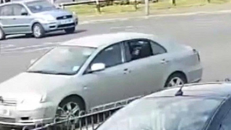 Vehicle showing someone point a gun out the back window