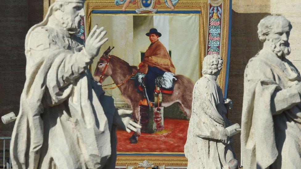 A tapestry hanged on the facade of St Peter's basilica shows a portrait of Jose Gabriel Brochero during a canonization mass led by Pope Francis, 16 October 2016