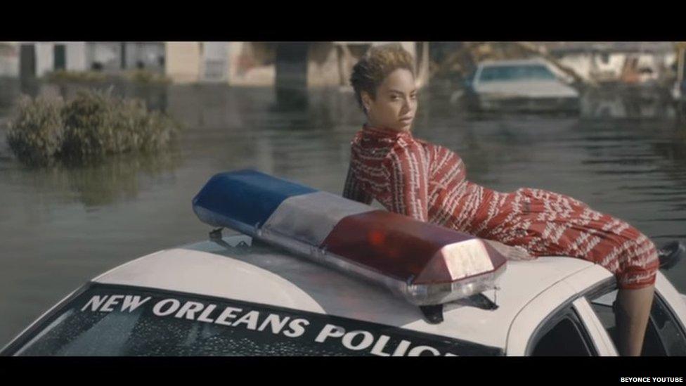 Beyonce on a submerged police car