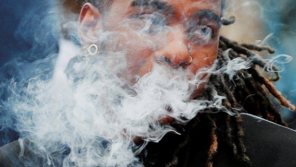 A demonstrator vapes during a protest of all vaping product sales in Boston, Massachusetts