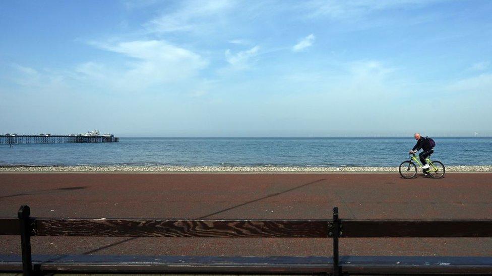 A cyclist rides in Llandudno