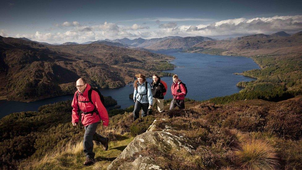 Walkers on Ben A'an overlooking Loch Katrine