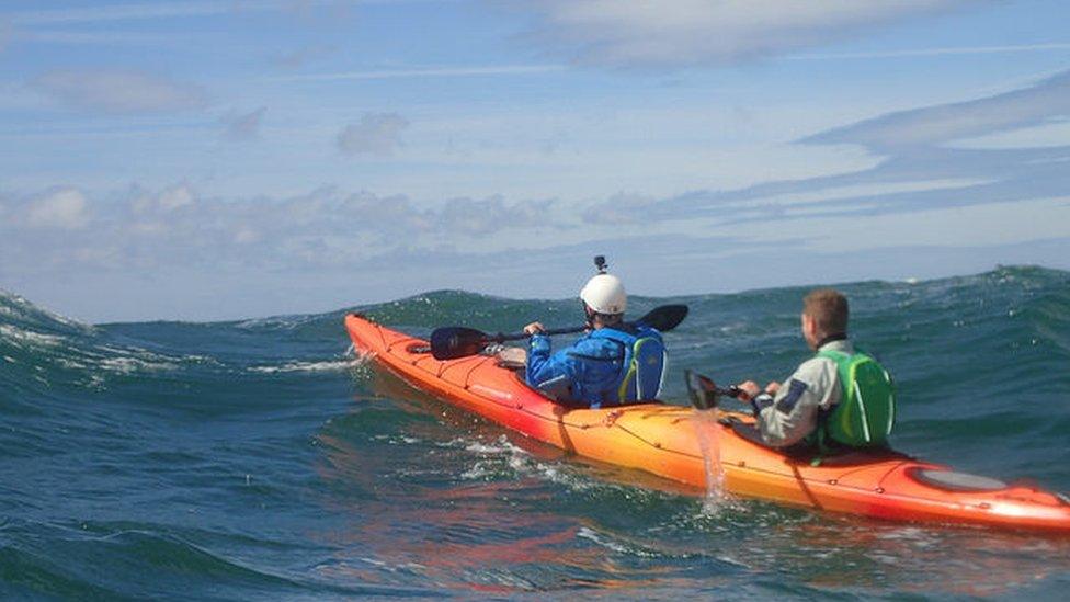 the pair kayaking in the sea