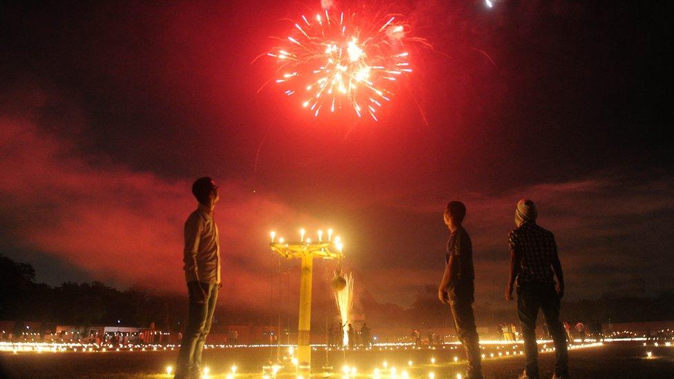 Indian athletes watch fireworks at the Madan Mohan Malviya stadium on the eve of the Hindu festival of Diwali in Allahabad on October 29, 2016