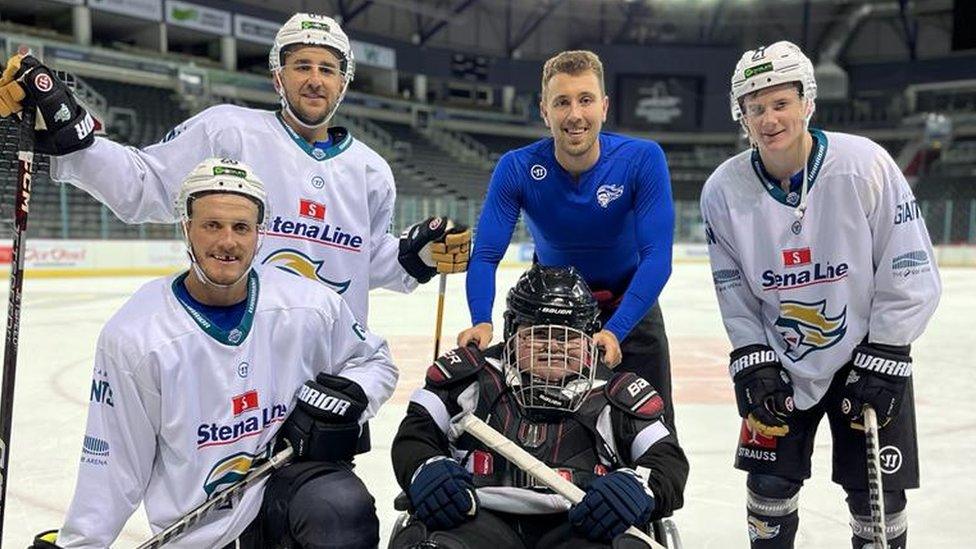 Ethan McClean with players in ice