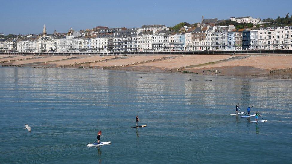 Paddle boarders in the sea at Hastings