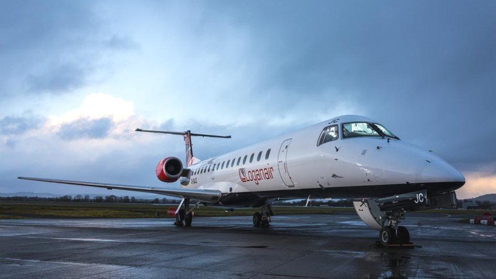 A Loganair plane stands at an airport