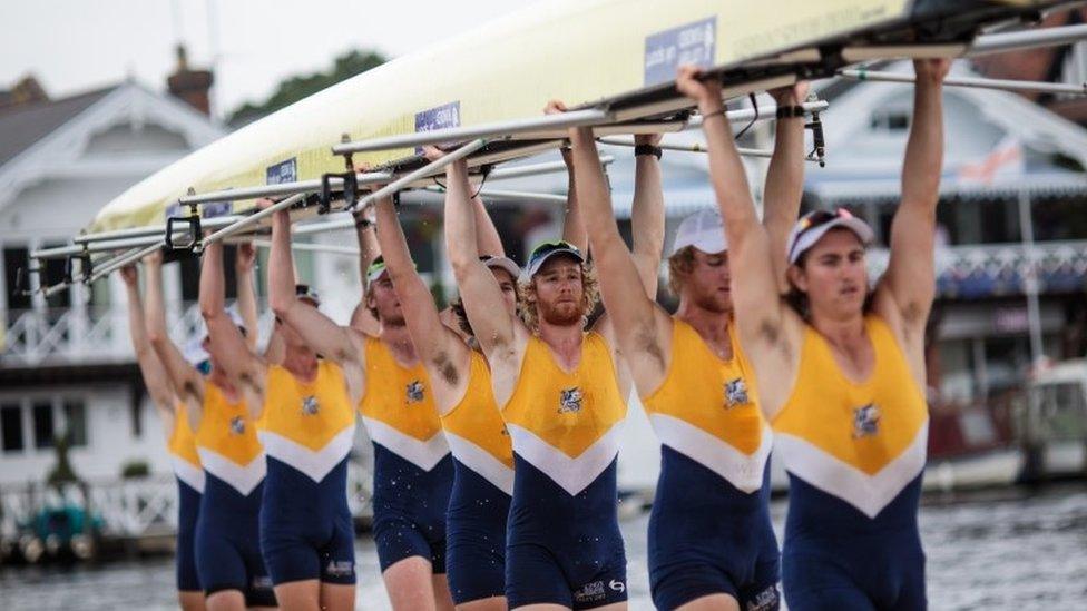 A crew carries boat at the Henley Royal Regatta