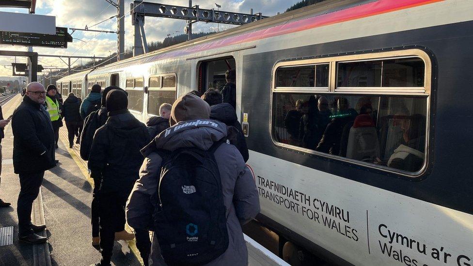 Commuters get on the Treherbert to Cardiff train on Monday