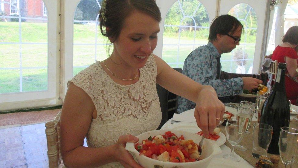 Bride serves herself some salad