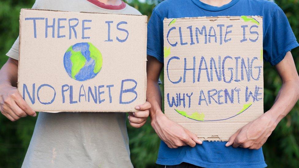 children holding up protest signs