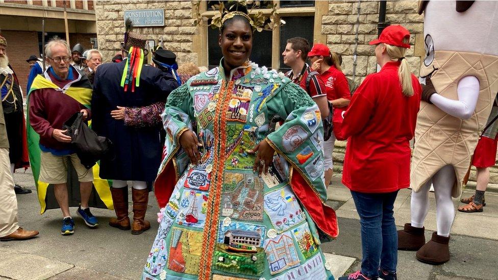 A woman in a brightly coloures costume