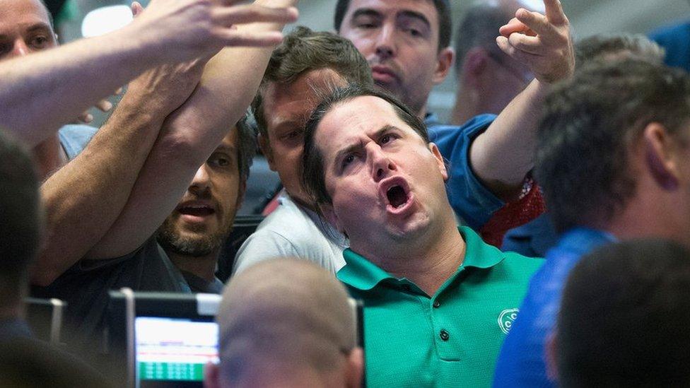 Traders signal offers in the Standard & Poor's 500 stock index options pit at the Chicago Board Options Exchange (CBOE) in Chicago, Illinois (24 Aug 2015)