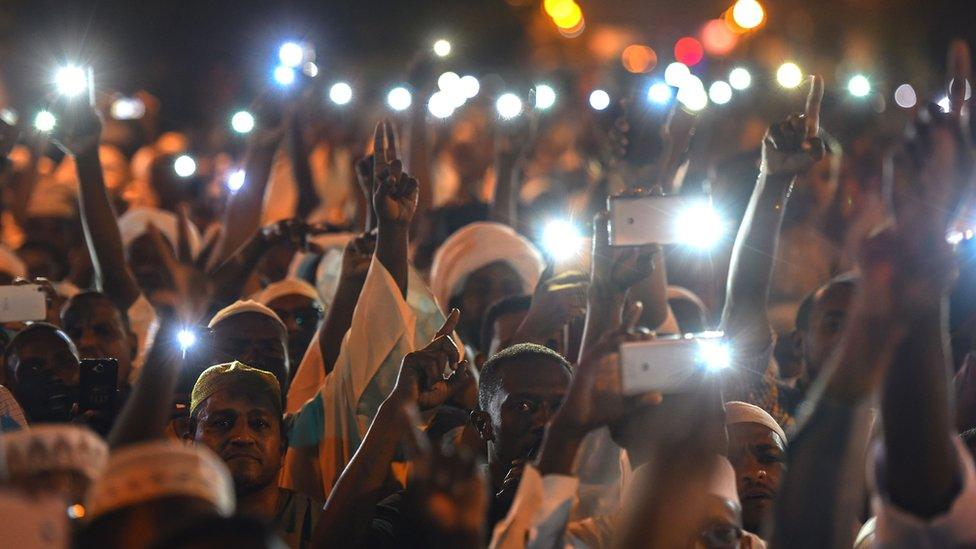 Demonstrators in Sudan with mobile phones at night - May 2019