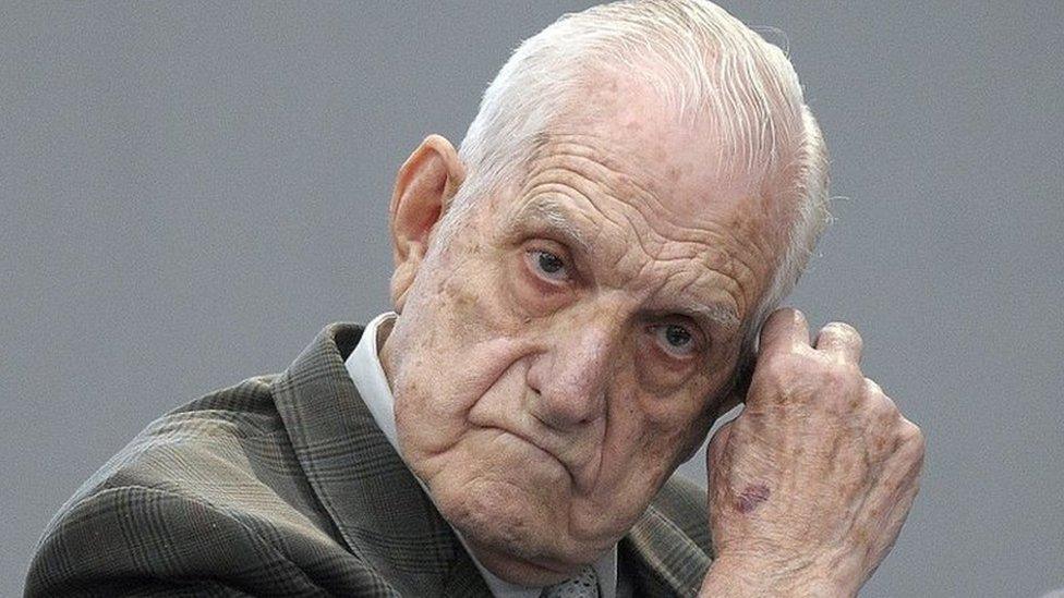 In this file picture taken on April 20, 2010, former Argentine de facto president and Army chief Reynaldo Bignone gestures at the courtroom before being sentenced during his trial, in Munro, Buenos Aires