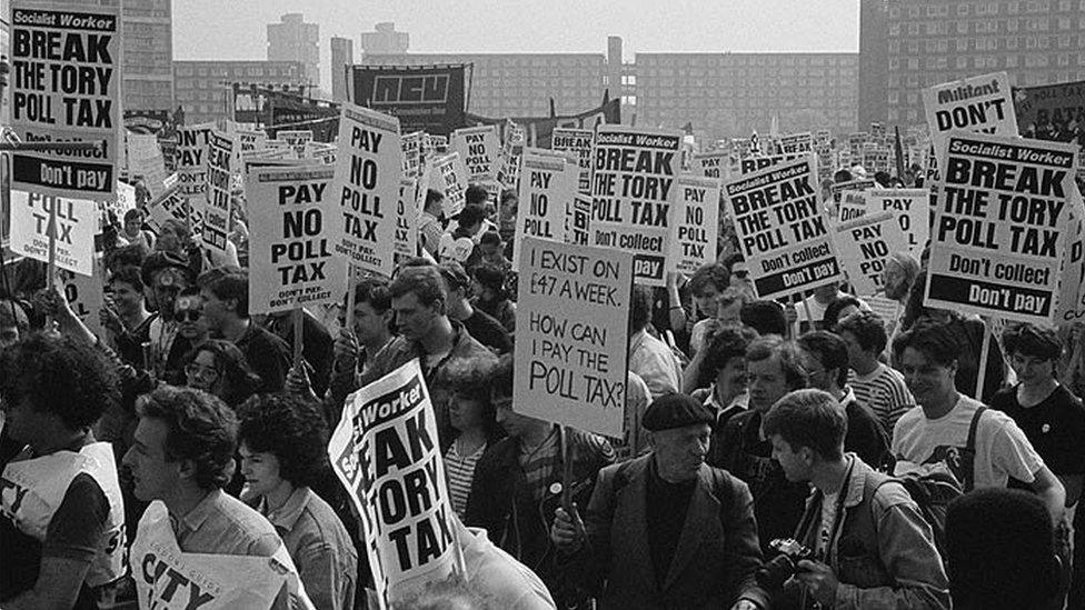 Protesters holding placards