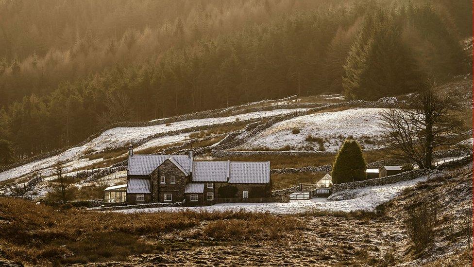 Snow covers a house in the North York Moors National Park