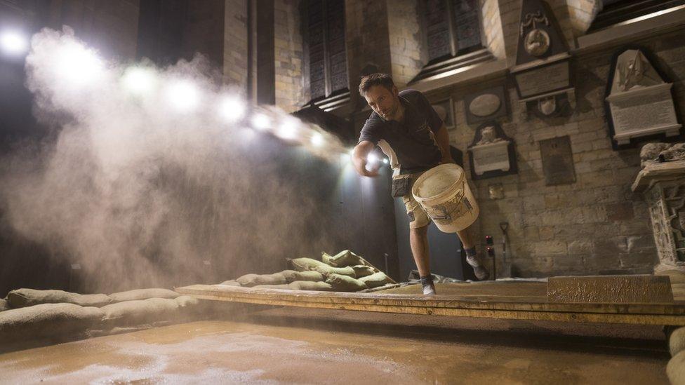 Dan Metcalfe throwing soil into a mud pit