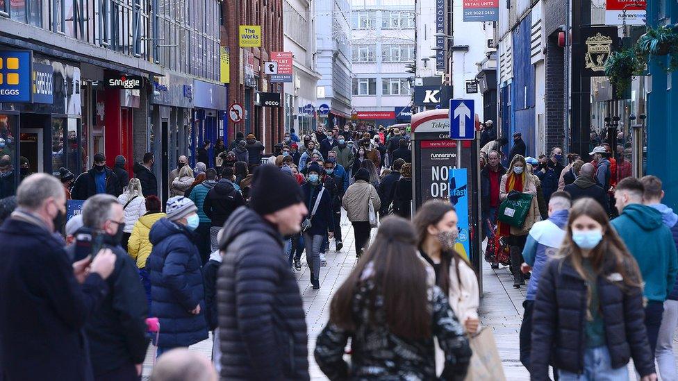 A busy shopping street in central Belfast during the day