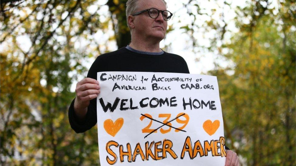 Man holds welcome home banner placard. Pictured on 30 October 2016.