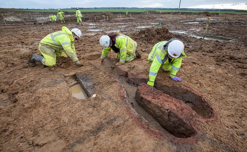 Archaeologists excavating the Roman kiln found at Field 44 on the A428