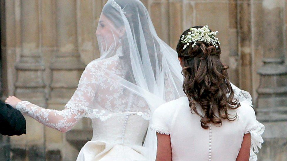 Pippa holding Kate's wedding dress