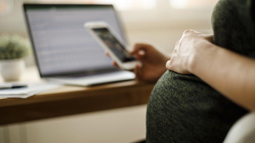 Pregnant woman at desk