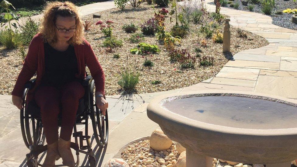 Photo shows Carrie-Ann Lightley in a garden