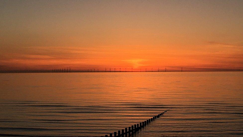 Sunset over the offshore wind farm off Rhyl, courtesy of Natalie Clements