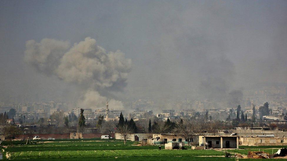 Smoke rises over the town of Misraba in the Eastern Ghouta region outside Damascus, 7 March