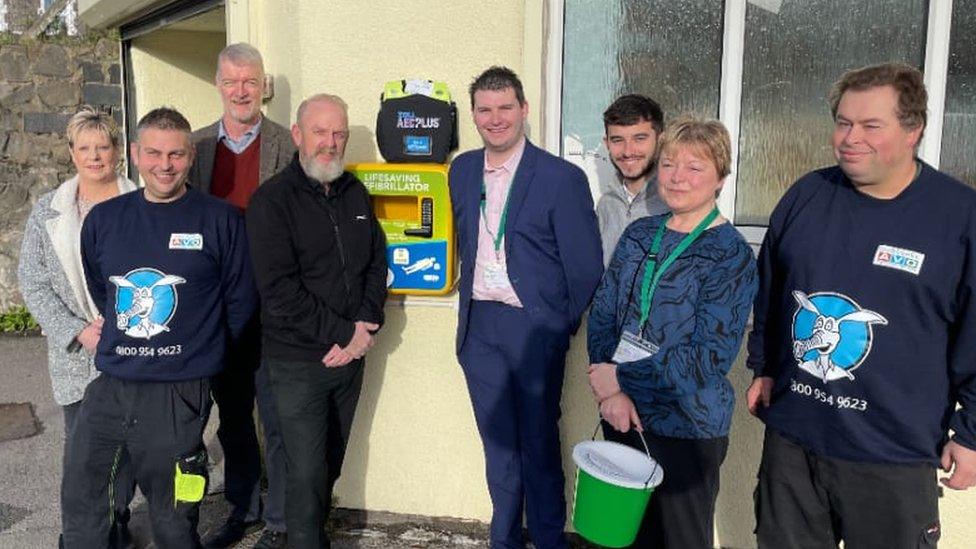 Josh Bell (fourth from left) and Donate For Defib installing defibrillators