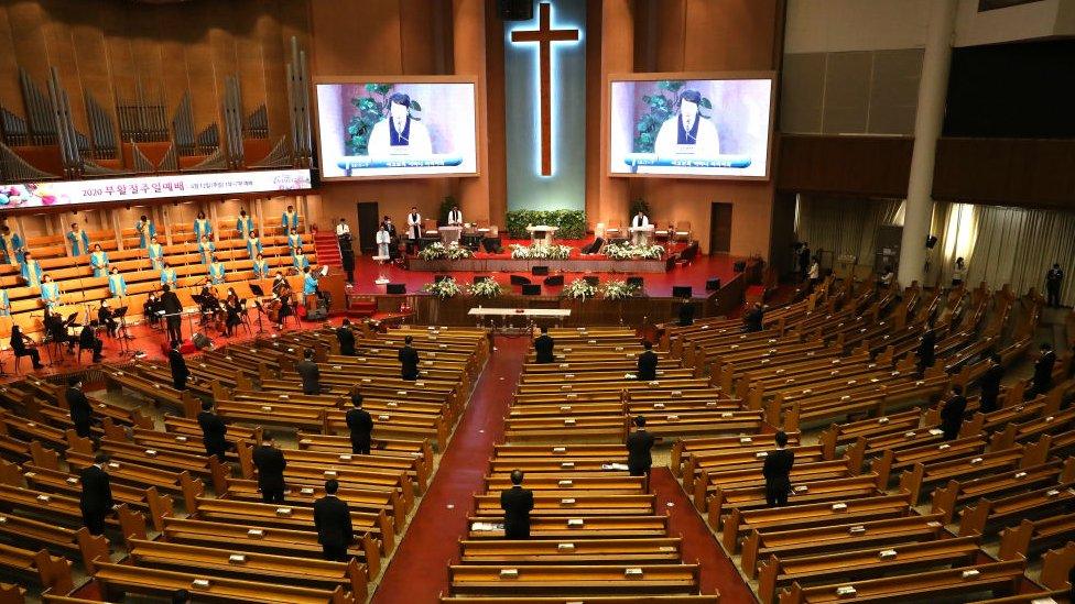 Pastors wear mask as they pray during a Easter worship