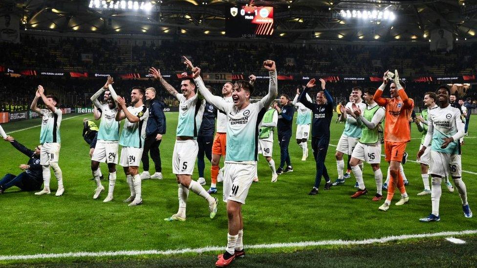 Brighton players celebrate after winning Europa League match