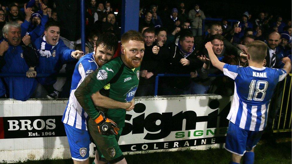 Coleraine players celebrate with supporters after beating Ballinamallard in a penalty shoot-out after their Irish Cup match ended 2-2