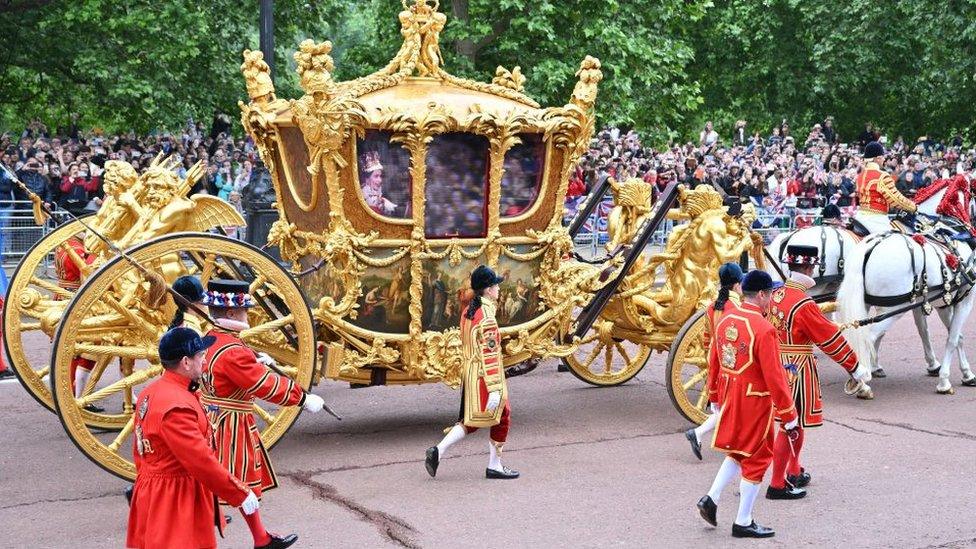 The golden State Carriage with a video projection of the Queen in the window, during the Platinum Pageant