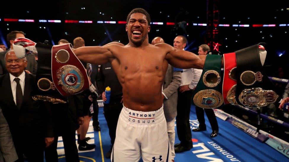 Anthony Joshua showing all his belts in 2017